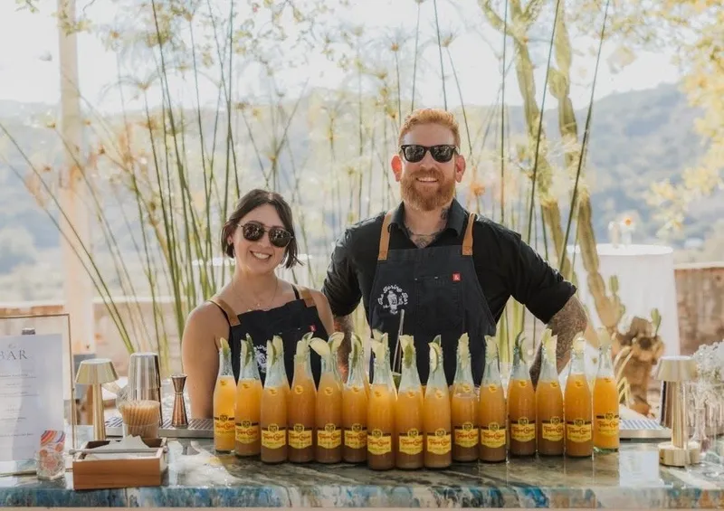 Bartender pouring an amber cocktail